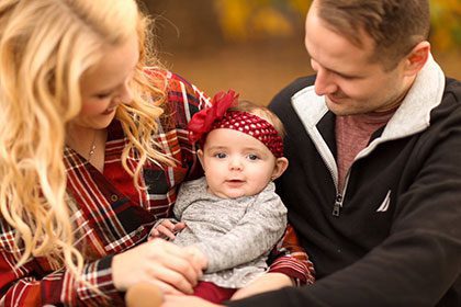 adoptive couple proudly show off their new baby for the camera