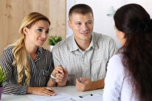 A young couple working with an adoption expert on their adoption home study